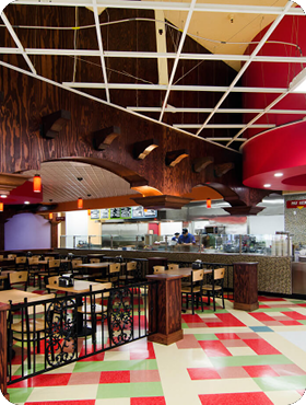 Restaurant with red, green and white checkered floor and wooden decoration.