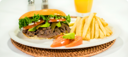 Torta with lettuce, tomato, avocado, and fries on a plate.